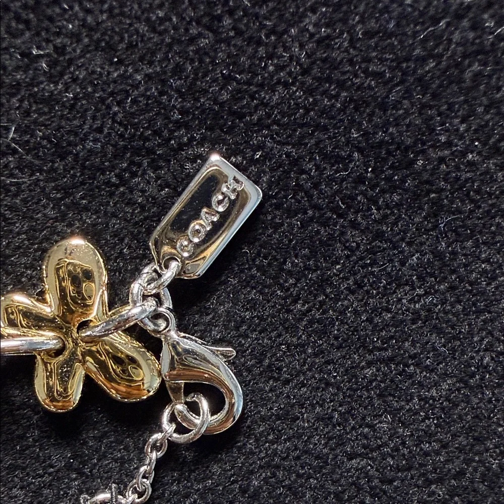 Coach Two-Tone Floral Charm Bracelet in Gold and Silver
